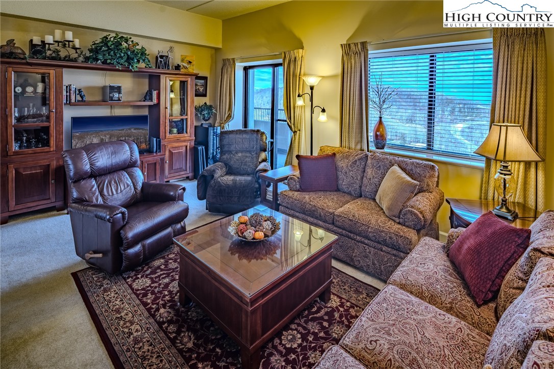 303 Sugar Top Drive, Unit 43427 Sugar Mountain, NC 28604 - Photo 5 of 18 a living room with furniture and a large window