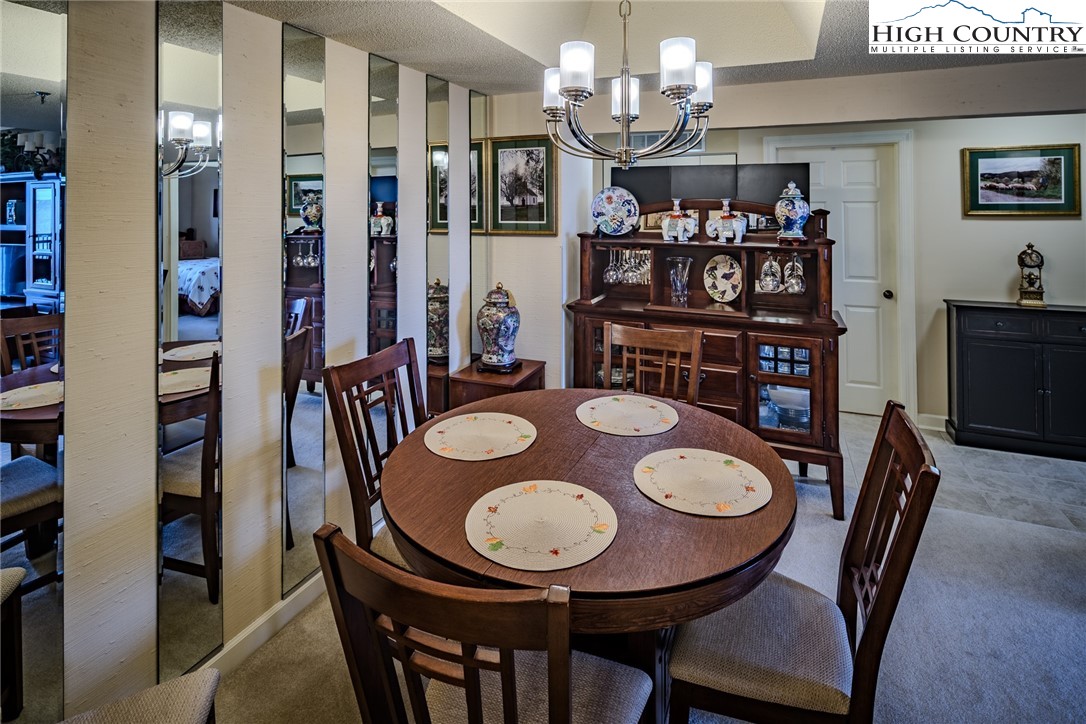 303 Sugar Top Drive, Unit 43427 Sugar Mountain, NC 28604 - Photo 8 of 18 a view of a dining room with furniture