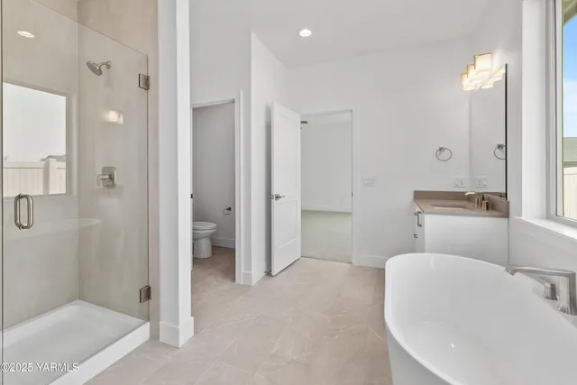 a spacious bathroom with a bathtub and shower
