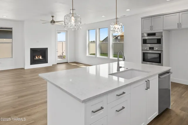 a view of kitchen with granite countertop cabinets and wooden floor
