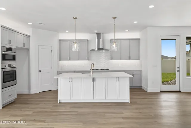 a bathroom with a shower sink and mirror