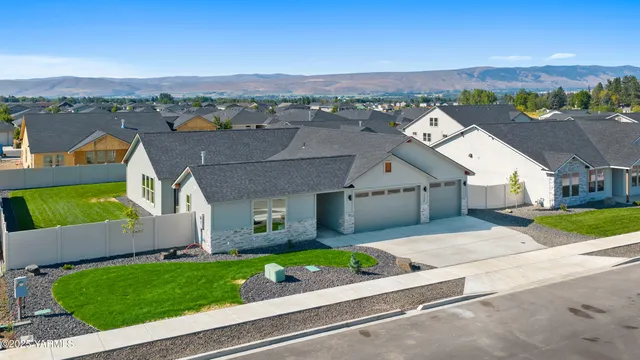 an aerial view of a house with a garden and lake view