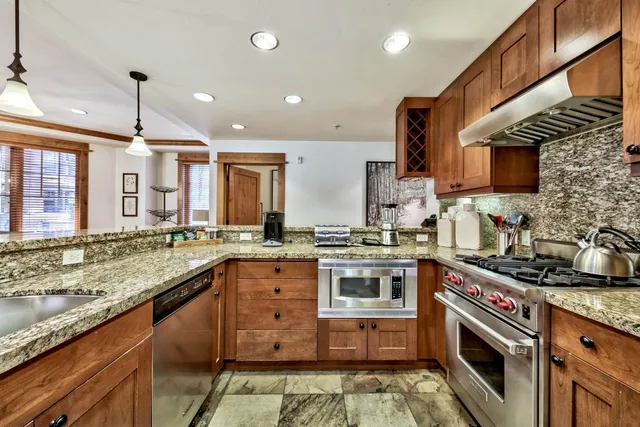 a bedroom with a bed and a dresser next to a window