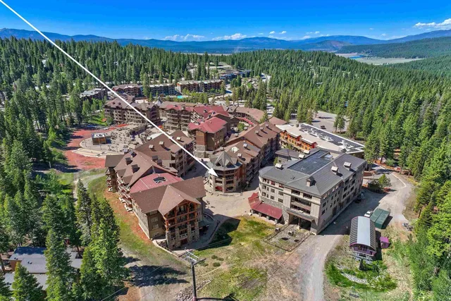 a view of a city with lots of residential buildings ocean and mountain view