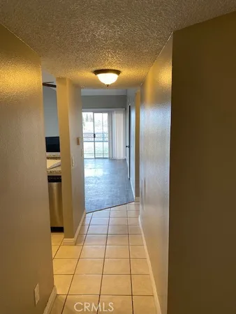 a view of hallway with a large window and a mirror