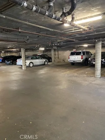 a view of parking garage with cars
