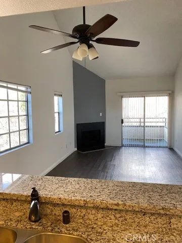 a living room with fireplace furniture and a wooden floor