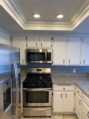 a kitchen with cabinets and stainless steel appliances