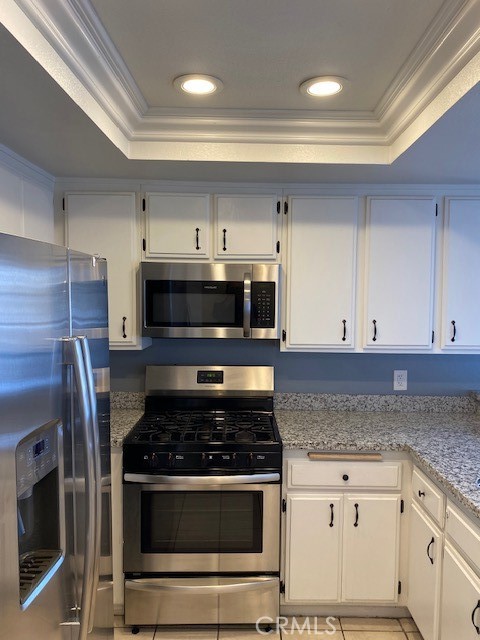 440 West 5th Street, Unit 305 Long Beach, CA 90802 - Photo 9 of 20 a kitchen with cabinets and stainless steel appliances