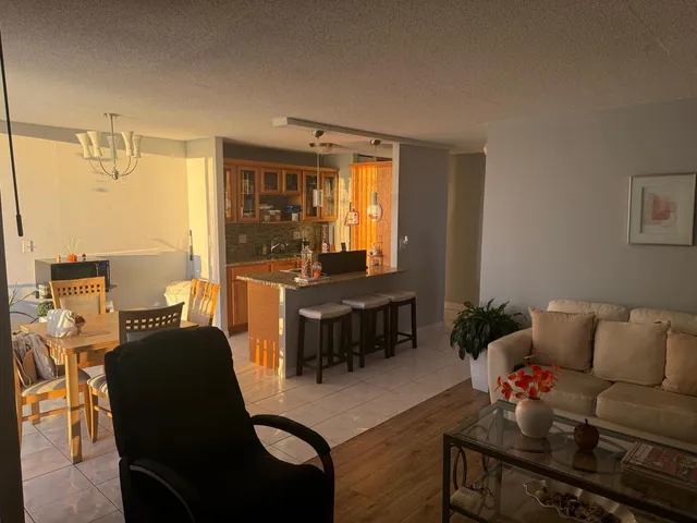 a dining room with furniture and chandelier