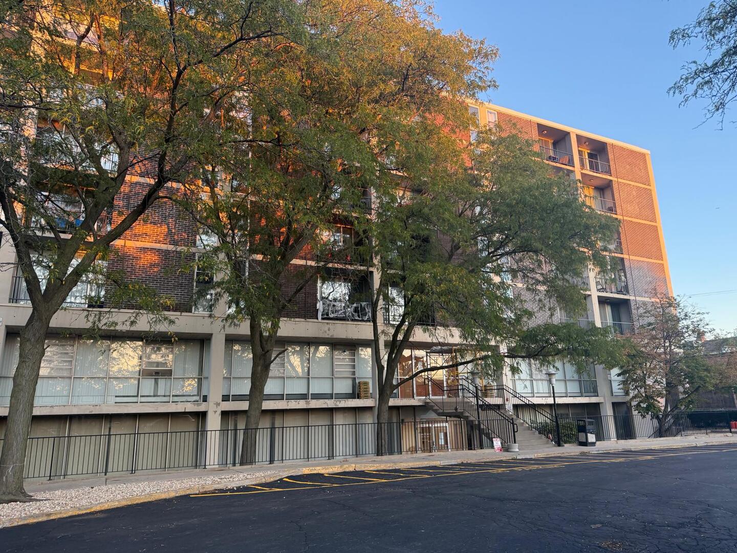 1043 South York Road, Unit 411 Bensenville, IL 60106 - Photo 2 of 31 a front view of a building with lake view and trees