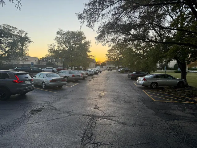 a view of a street with a car parked on the road