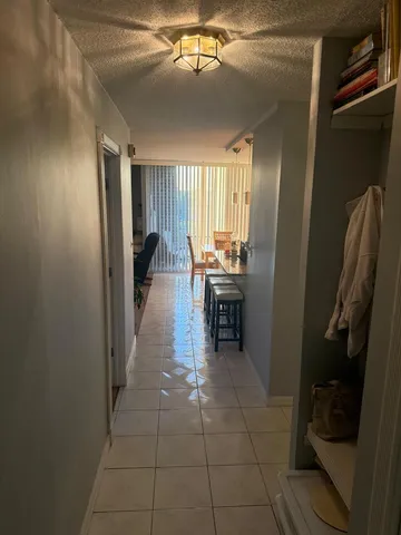 a room with washing machine and chair