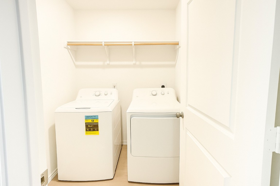 461 Whoopers Loop Uhland, TX 78640 - Photo 8 of 12 a utility room with dryer and washer