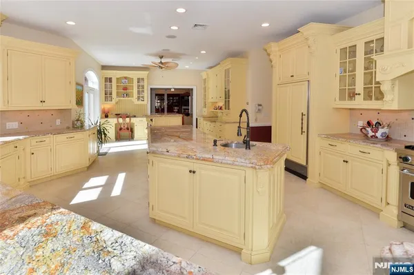 a large white kitchen with a large window