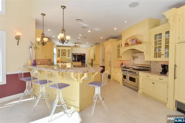 a kitchen with stainless steel appliances kitchen island granite countertop a table and chairs in it