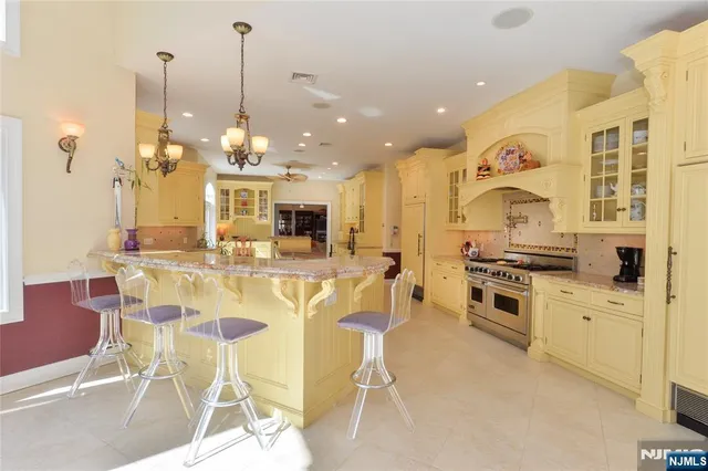 a kitchen with stainless steel appliances kitchen island granite countertop a table and chairs in it