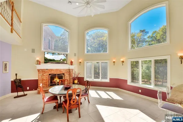 a living room with furniture a fireplace and a large window