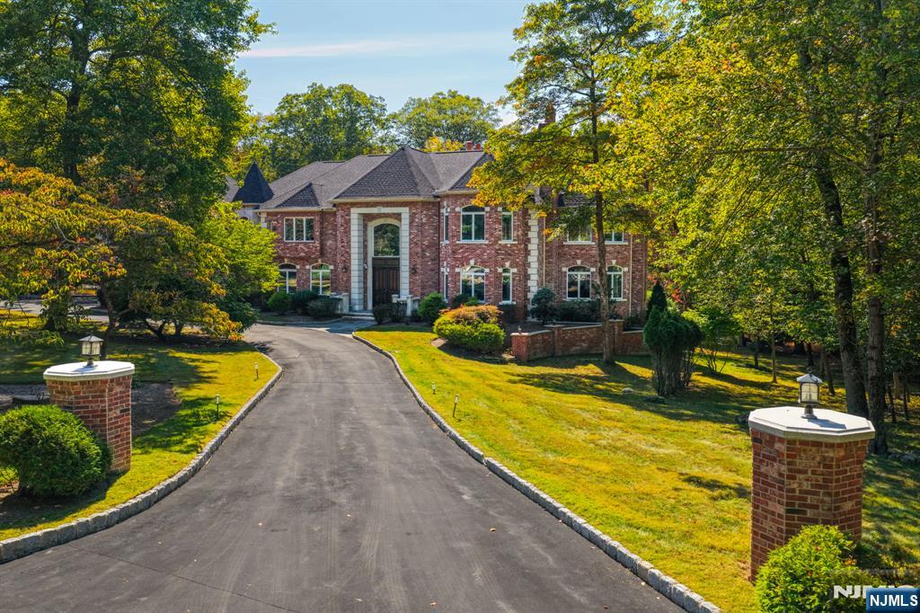 14 Werimus Brook Road Saddle River, NJ 07458 - Photo 2 of 50 a view of a house with swimming pool and a chairs