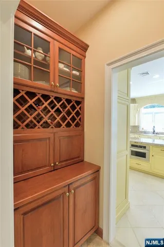 a view of a refrigerator and wooden cabinets