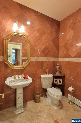 a bathroom with a toilet a sink and mirror