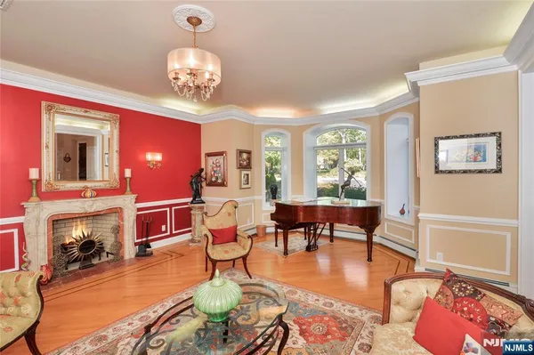 a living room with fireplace furniture and a chandelier