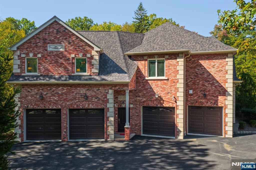 14 Werimus Brook Road Saddle River, NJ 07458 - Photo 3 of 50 a front view of a house with a garden