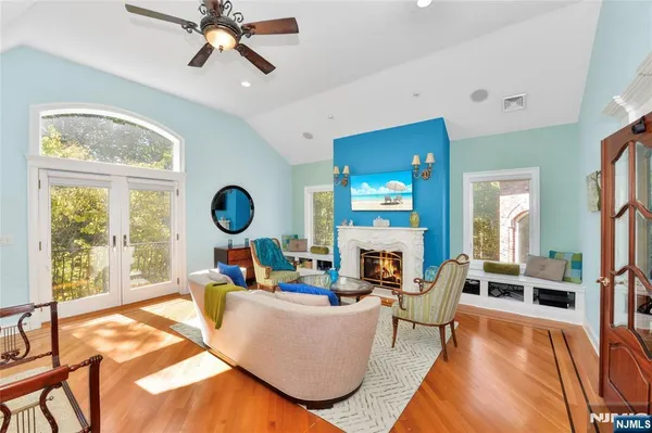 a living room with fireplace furniture and a large window