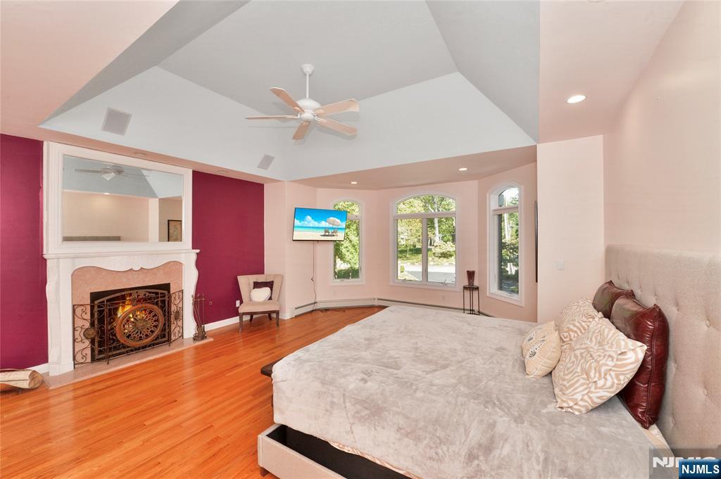 14 Werimus Brook Road Saddle River, NJ 07458 - Photo 40 of 50 a bed room with a bed a fireplace and a large window