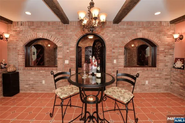 a living room with fireplace furniture and a chandelier