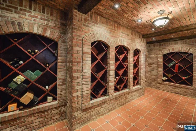 a view of an empty room with wooden floor and a fireplace
