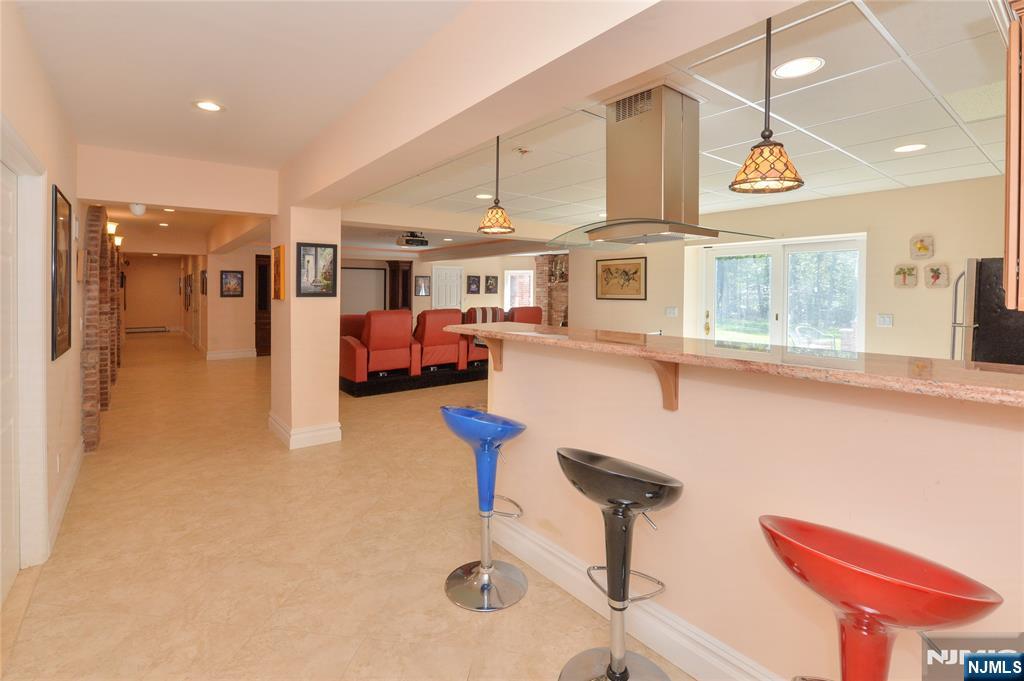 14 Werimus Brook Road Saddle River, NJ 07458 - Photo 46 of 50 a kitchen with stainless steel appliances kitchen island granite countertop a refrigerator and a stove