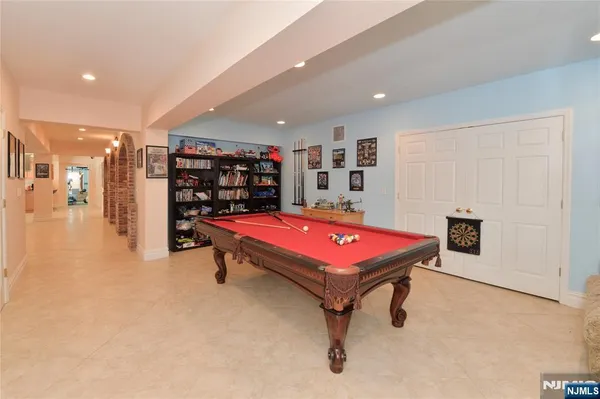 a room with pool table and windows