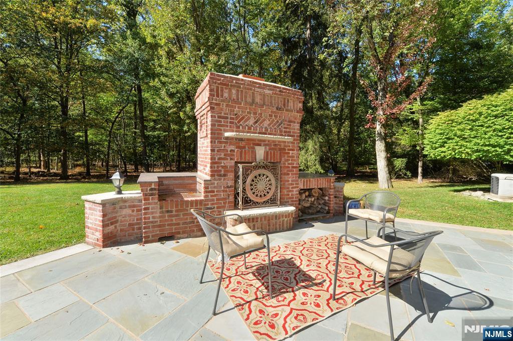14 Werimus Brook Road Saddle River, NJ 07458 - Photo 49 of 50 a view of a chairs and table in the yard