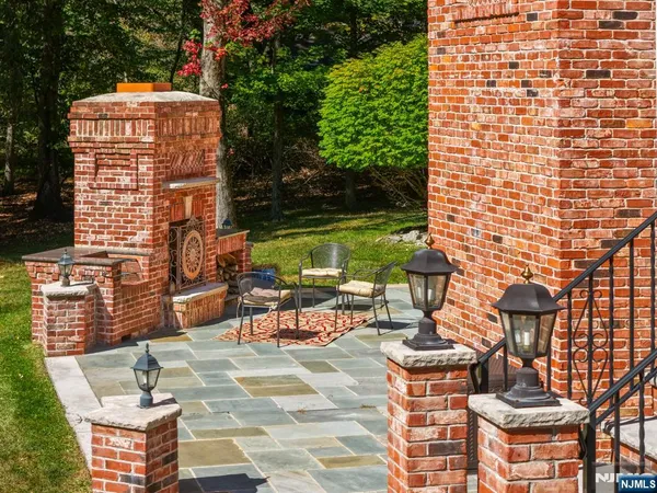 a view of a patio with table and chairs and potted plants