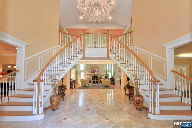 a view of staircase with lots of frames on wall and a large window