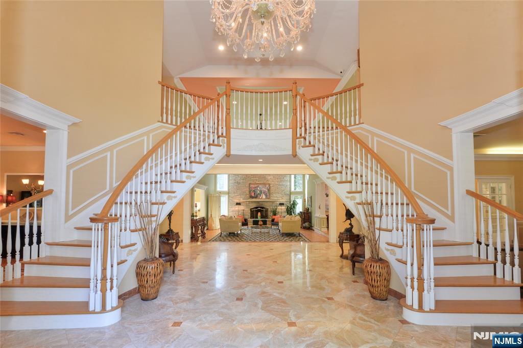 14 Werimus Brook Road Saddle River, NJ 07458 - Photo 9 of 50 a view of staircase with lots of frames on wall and a large window
