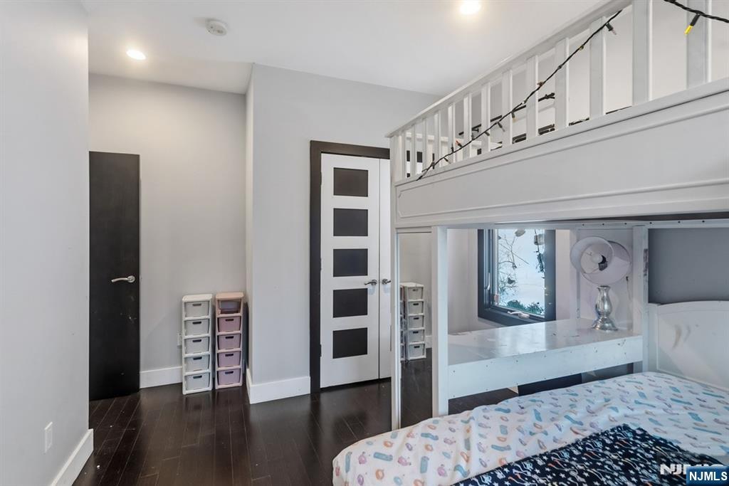 760 Undercliff Avenue, Unit B Edgewater, NJ 07020 - Photo 45 of 49 a bedroom with a bed and wooden floor