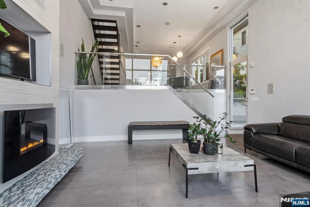 760 Undercliff Avenue, Unit B Edgewater, NJ 07020 - Photo 5 of 49 a living room with furniture and a fireplace