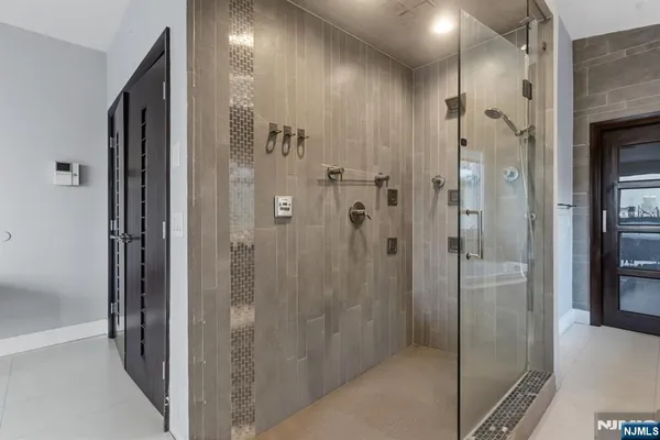 a bathroom with a shower and a glass door
