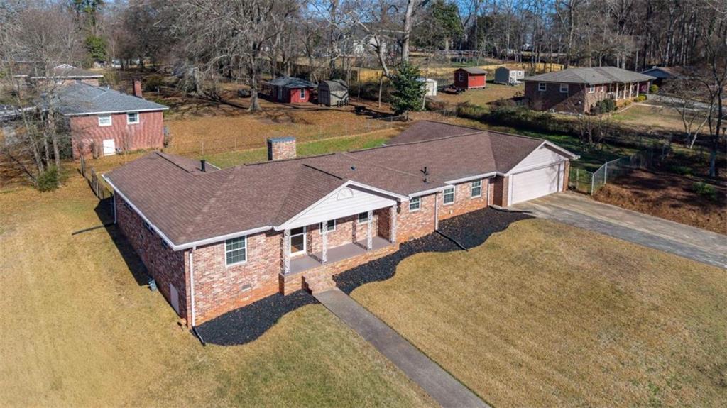a aerial view of a house with swimming pool and sitting area