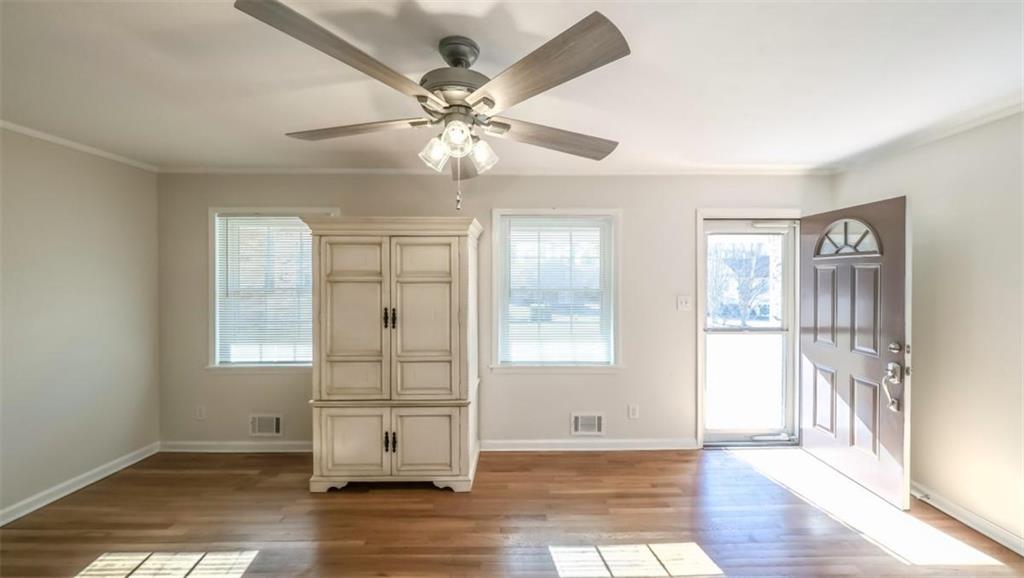 4045 Compton Circle Powder Springs, GA 30127 - Photo 16 of 54 a view of an empty room with wooden floor and fan
