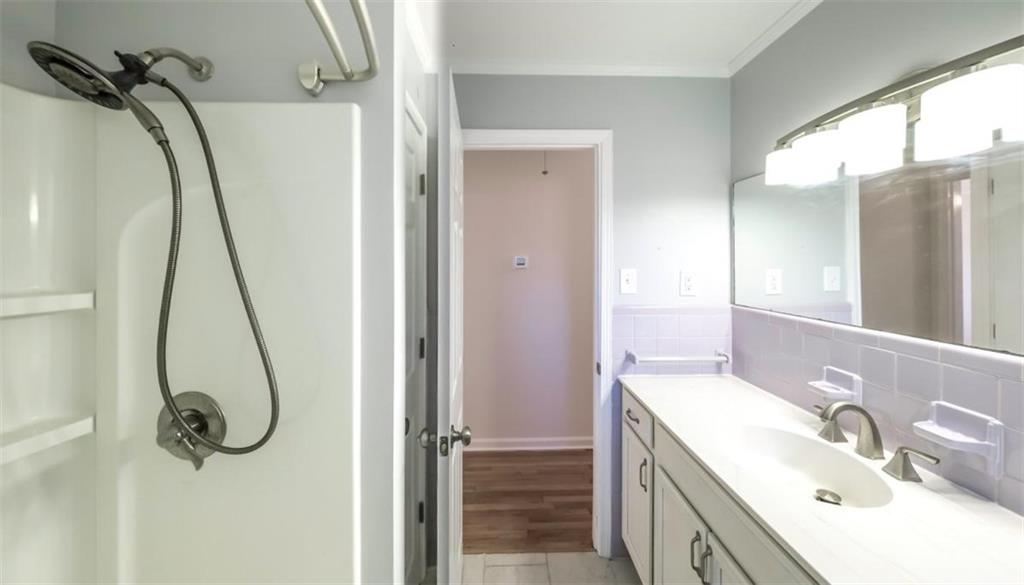 4045 Compton Circle Powder Springs, GA 30127 - Photo 22 of 54 a bathroom with a granite countertop sink vanity mirror and shower