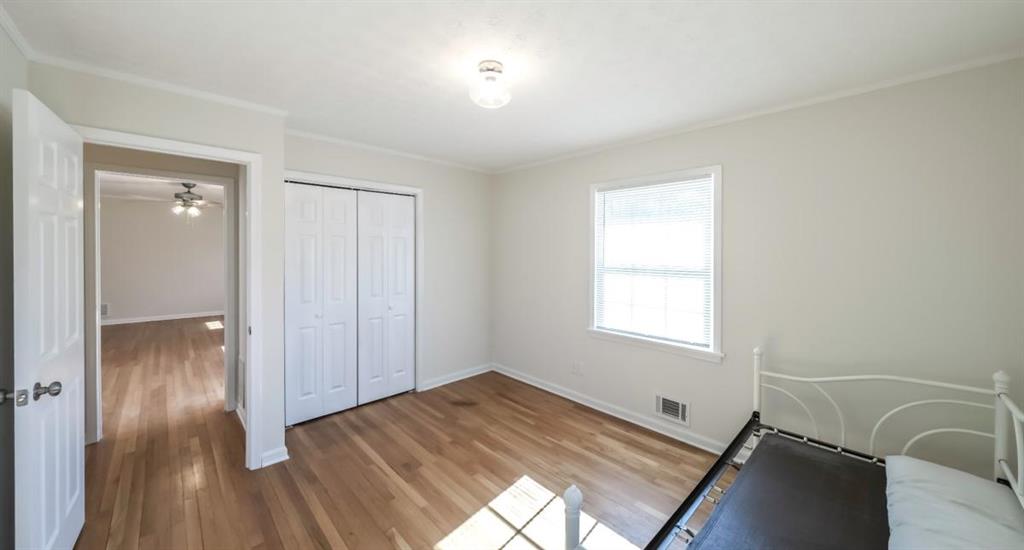 4045 Compton Circle Powder Springs, GA 30127 - Photo 32 of 54 an empty room with wooden floor and windows