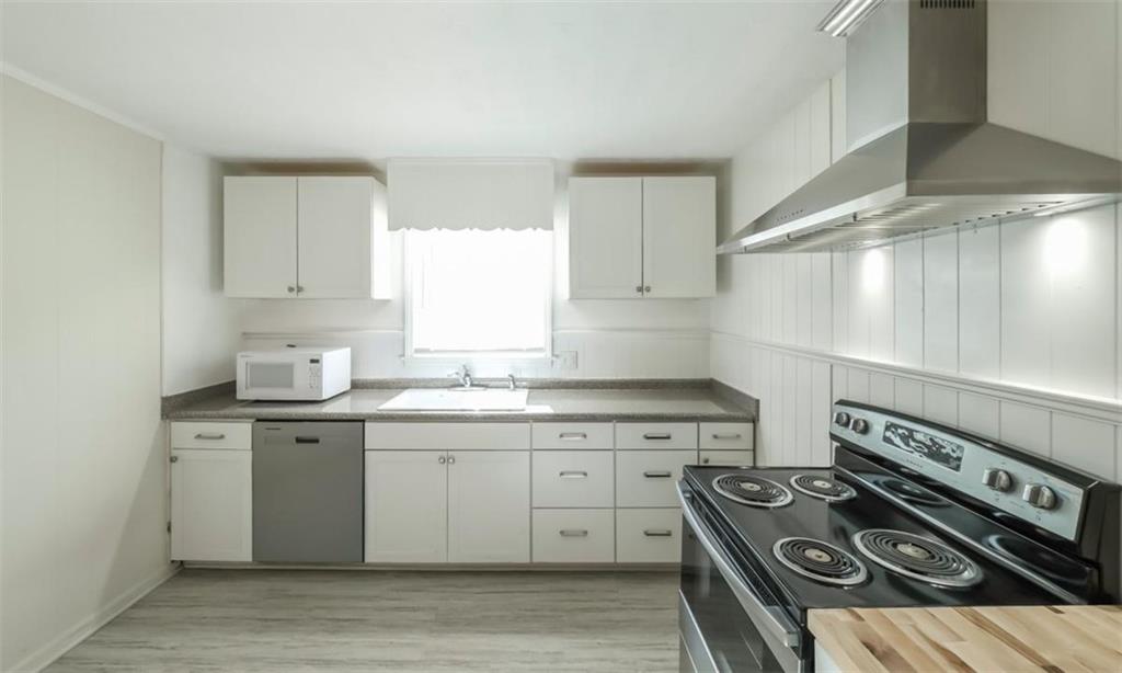 4045 Compton Circle Powder Springs, GA 30127 - Photo 33 of 54 a kitchen with a stove sink and cabinets