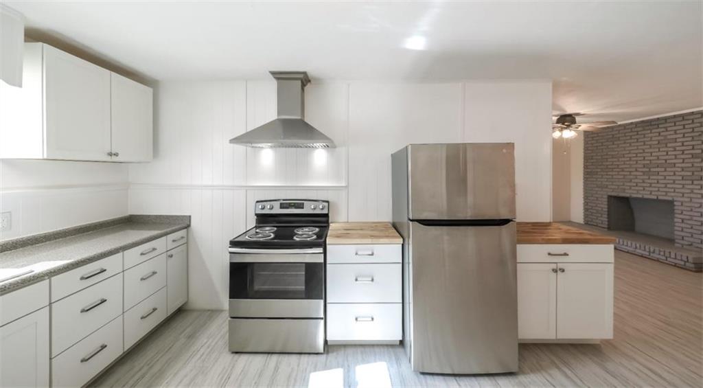 4045 Compton Circle Powder Springs, GA 30127 - Photo 34 of 54 a kitchen with white cabinets and white appliances