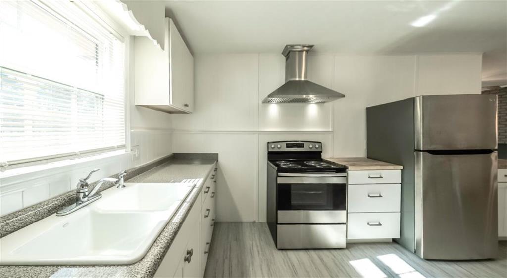 4045 Compton Circle Powder Springs, GA 30127 - Photo 35 of 54 a kitchen with a stove a refrigerator and a sink