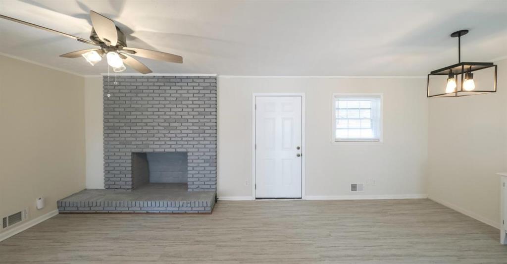 4045 Compton Circle Powder Springs, GA 30127 - Photo 39 of 54 a view of an empty room with wooden floor and a fireplace