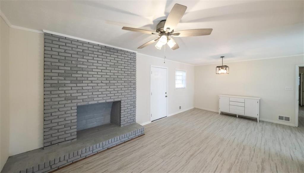 4045 Compton Circle Powder Springs, GA 30127 - Photo 40 of 54 a view of an empty room with wooden floor a fireplace and a window