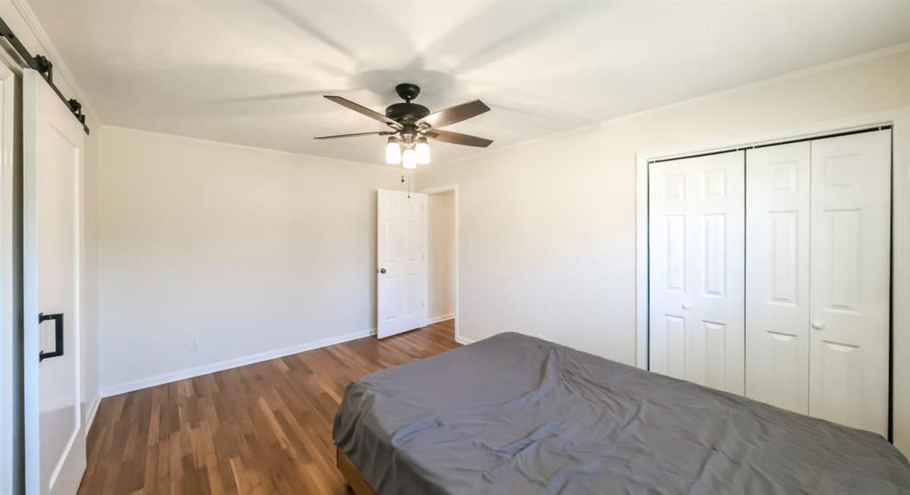 4045 Compton Circle Powder Springs, GA 30127 - Photo 47 of 54 a bedroom with a large bed and a chandelier